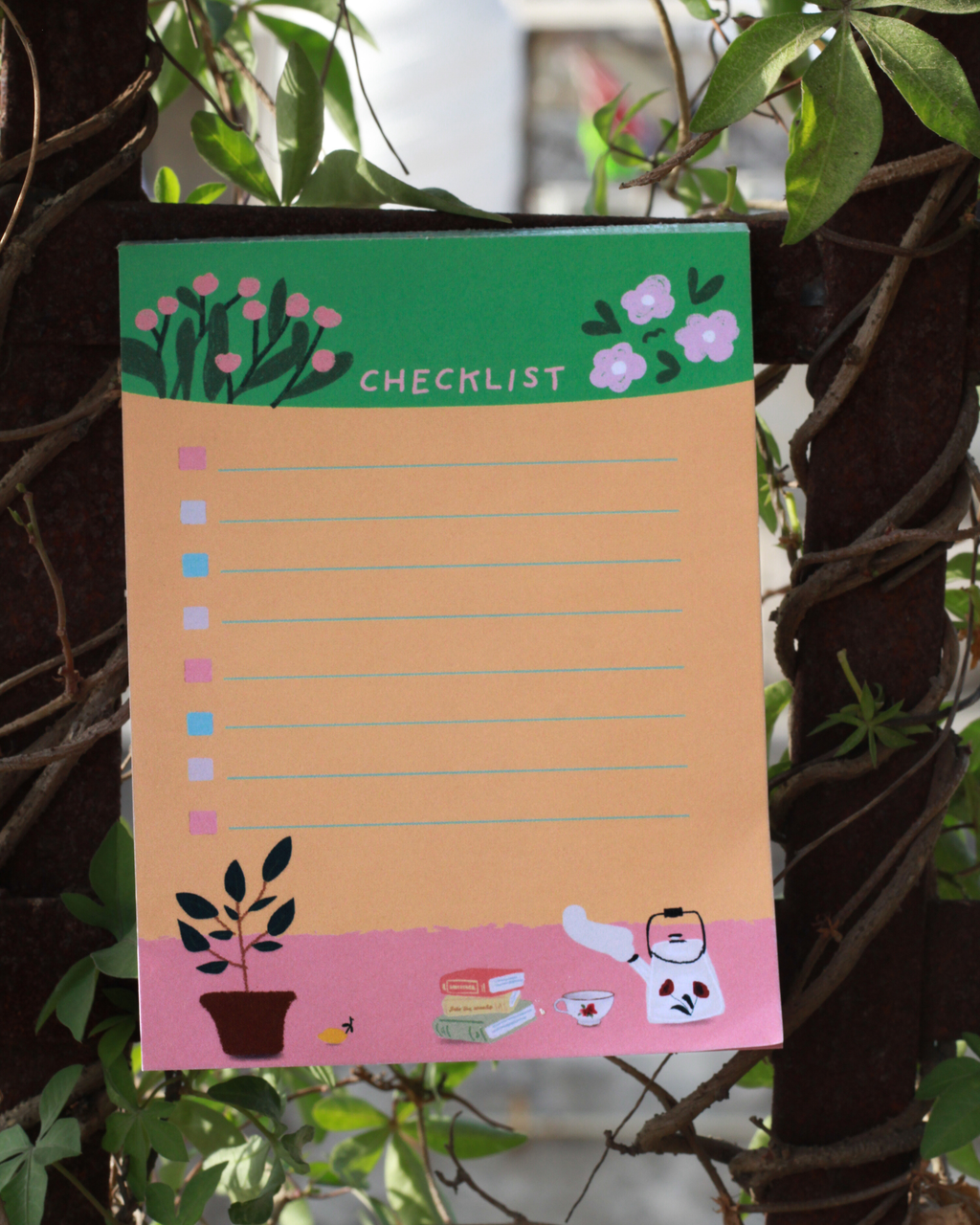 Checklist notepad with floral design on a plant background