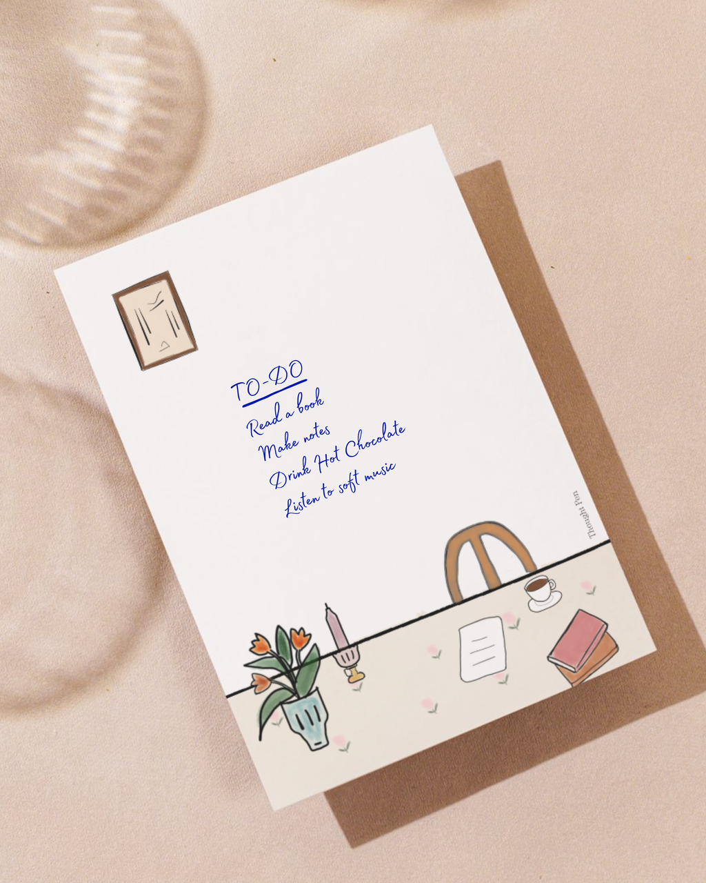 notepad with table and chair  illustrations and text on a beige background